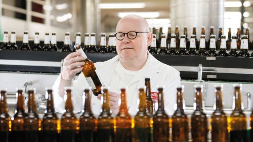 Master brewer during the quality check in the brewery's bottling plant