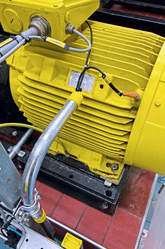 Close-up of an industrial water pump with vibration sensor