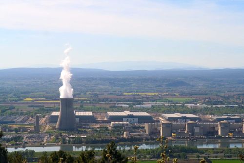 A power plant next to a river flow.