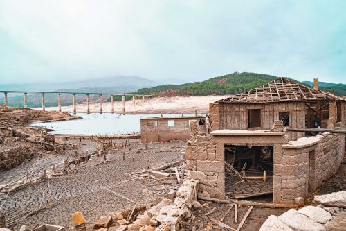 The low water level of the Alto-Lindoso reservoir exposes the former village of Aceredo, which is normally flooded by dammed water.